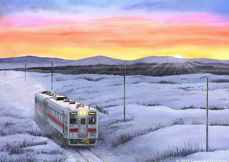 初日の出を受けて雪原を走る釧網本線